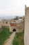 Panoramic view of courtyard of Hukvaldy medieval castle with colorful autumn forest and mountains on the background