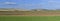 Panoramic view of cultivated farmland with sky