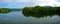 Panoramic view of dam water surrounded with green trees in Kuala Kubu Bharu, Selangor, Malaysia.