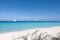 Panoramic view of deserted tropical beach with sailing ship on turquoise sea