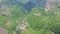 Panoramic View Distant Waterfall among Hilly Lands with Plants