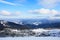 Panoramic view of Dragobrat ski resort from above. Mountain winter snowy landscape from ski slope. Wooden cottages and