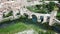 Panoramic view from drone of fortified village of Besalu with Fluvia river and medieval arched bridge, Spain