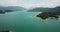 Panoramic view from the drone of the sea coast of the islands and a small motor boat below
