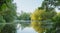 Panoramic view of early sunny morning lake with green trees  morning mist and tranquil reflection. Estonia  Harku.