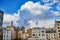 Panoramic view of the Eiffel tower with cloudscape over the roofs of residential buildings in Paris, France