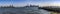 Panoramic view of Ellis Island and the New York Skyline under a beautiful blue sky, typical of the Big Apple.