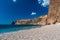 Panoramic view of empty pebble beach with clear azure blue water and layered rocks, Jasper Beach, Fiolent, Balaklava, city