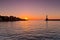 Panoramic view of the entrance to Chania harbor with lighthouse at sunset, Crete