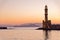 Panoramic view of the entrance to Chania harbor with lighthouse at sunset, Crete