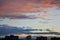 Panoramic view of the evening autumn sky and beautifully sunlit clouds over the city rooftops