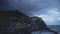 Panoramic view of evening Manarola village and waves crashing over rocks