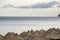 Panoramic view of the evening sea, beautiful big cloud, the ship in the distance and is a lot of straw umbrellas.