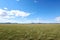 a panoramic view of an expansive, open grassland