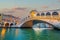 Panoramic view of famous Canal Grande with famous Rialto Bridge at sunset, Venice