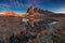 Panoramic view of famous Dolomites mountain peaks and lakes glowing in beautiful golden morning light at sunrise in summer.