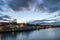 Panoramic view of the famous skyline of Regensburg in Bavaria seen from the Stone Bridge with dramatic clouds in evening sky