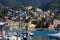 Panoramic view of the famous touristic city of Rapallo in northern Italy. Small town perched on a hill. Boats in the port