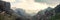 Panoramic view of fantastic mountains range in fog on sunset,