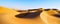 panoramic view featuring pure golden sand dunes under a serene blue sky with copy space