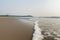 Panoramic view of foamy sea waves of Arabian Sea swashing on sandy Gokarna Main Beach, Karnataka, India