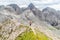 Panoramic view of a girl climber standing on the top of cliff in Dolomites Mountains. Italian Dolomites. Panoramic view of girl wa