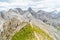 Panoramic view of a girl climber standing on the top of cliff in Dolomites Mountains. Italian Dolomites. Panoramic view of girl wa