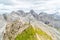 Panoramic view of a girl climber standing on the top of cliff in Dolomites Mountains. Italian Dolomites. Panoramic view of girl wa