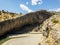 Panoramic view of the gorge with prehistoric caves over the the wide and almost dry river bed. Cendere stream. Turkey