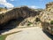 Panoramic view of the gorge with prehistoric caves over the the wide and almost dry river bed. Cendere stream. Turkey