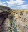 Panoramic view of the gorge with prehistoric caves over the the wide and almost dry river bed. Cendere stream. Turkey