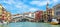 Panoramic view of Grand Canal, Venice, Italy. Rialto Bridge in the distance. It is famous landmark of Venice