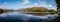 Panoramic view of Grasmere Lake with reflections  in The Lake District from the shore side in Cumbria
