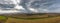 Panoramic view of green agricultural fields at winter time