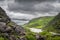 Panoramic view on green mountain hills and a lake in Gap of Dunloe