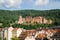 Panoramic view of Heidelberg castle over the tile roofs of old town from Carl Theodor bridge