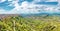 Panoramic view of the hills, the city of Enna on the right and the valley with green luagmi and forests in Sicily