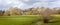 Panoramic view of historic Lacock Abbey across the fields from the south side in Lacock, Wiltshire, UK
