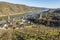 Panoramic view of historical town Oberwesel on the Rhine river with vineyards and barges under blue sky and sunshine