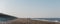 Panoramic view of Horsey Gap beach in spring, silhouettes of people walking by the water on the background., Norfolk, UK