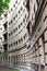 Panoramic view of a house in the city of St. Petersburg. Architectural solution with several balconies. Beige color plaster.