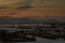 Panoramic view of houses on Savlje region of Ljubljana with visible magical yellow skies in the evening and julian alps with