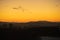 Panoramic view of houses on Savlje region of Ljubljana with visible magical yellow skies in the evening and julian alps with