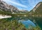 Panoramic view of iconic mount Seekofel mirroring in the clear calm water of  Pragser Wildsee Lago di Braies in Dolomites, Italy