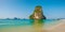 Panoramic view of idyllic Railay Beach in Thailand with rock islands and a traditional longboat