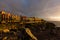 Panoramic view of the Illuminated Las Americas at night against the colorful sunset sky with lights on the horizon on