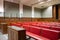 Panoramic view of interior courtroom in court of justice with witness desk and defense