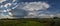 Panoramic view of an isolated thunderstorm with elongated anvil over the countryside of Transylvania, Romania.