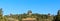 Panoramic view of Jingshan Park Beijing. Traditional Chinese-style pavilions on a hill against a blue sky.