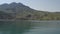 Panoramic view. Kayak swimming along coastal strip and majestic mountain